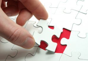 hands holding a puzzle piece . business concepts